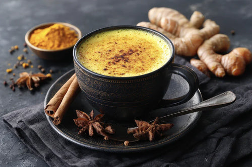Tasse de golden milk, boisson chaude au lait et curcuma, décorée de poudre de cannelle.