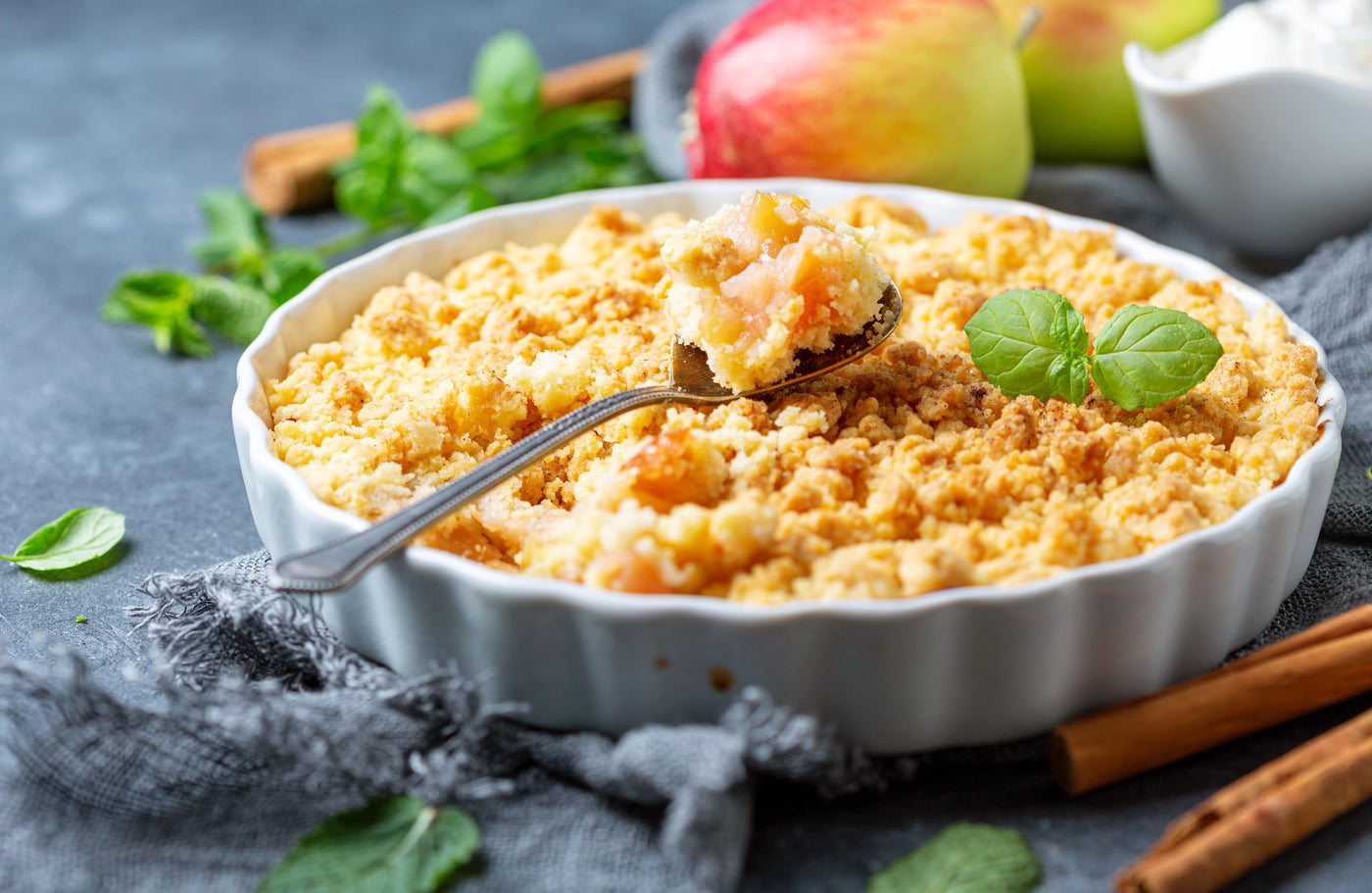 Portion de Crumble aux pommes servi sur une assiette blanche